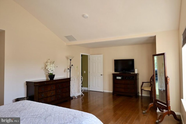 bedroom featuring lofted ceiling and dark hardwood / wood-style floors