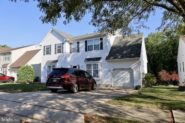 view of front of home with a front yard and a garage