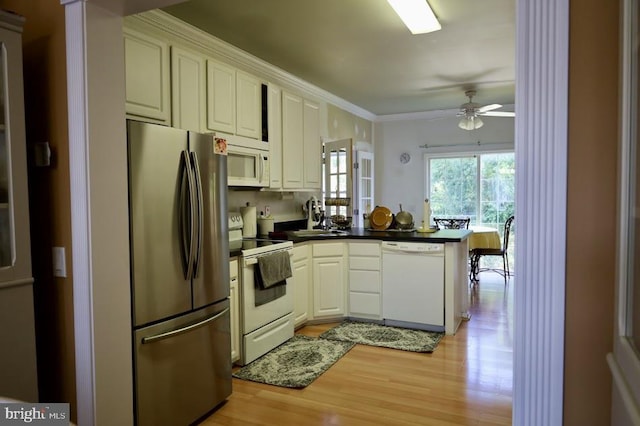 kitchen with ceiling fan, white cabinets, white appliances, kitchen peninsula, and light hardwood / wood-style flooring