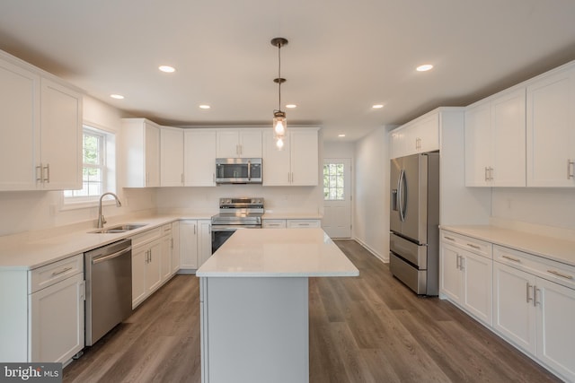 kitchen featuring a wealth of natural light, appliances with stainless steel finishes, sink, and a center island