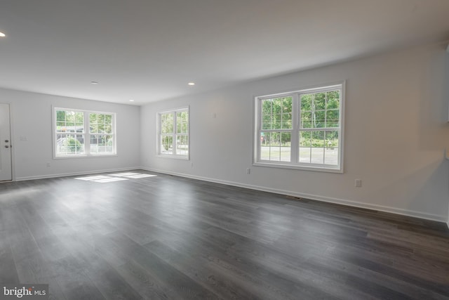 spare room with dark hardwood / wood-style floors