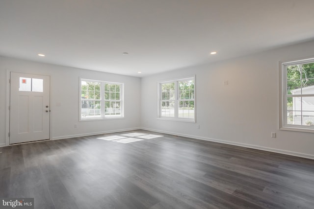 empty room with dark hardwood / wood-style flooring