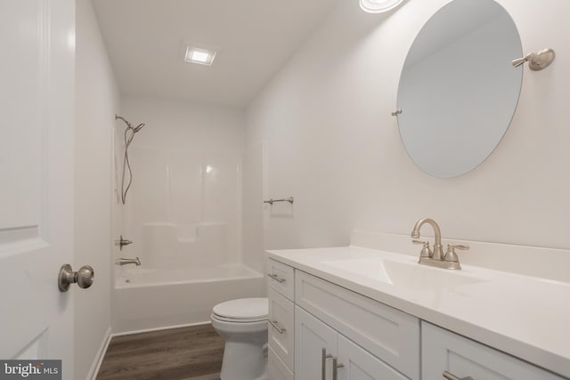 full bathroom with hardwood / wood-style flooring, bathtub / shower combination, vanity, and toilet