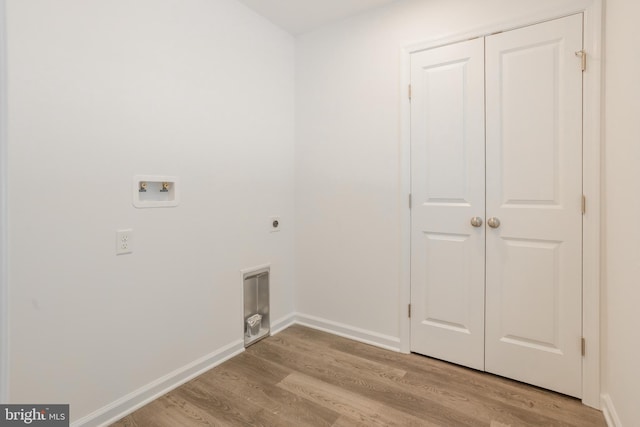 34709 Bowman Ln, Frankford, DE 19945 - laundry area with light wood-type flooring, electric dryer hookup, washer hookup, and baseboards