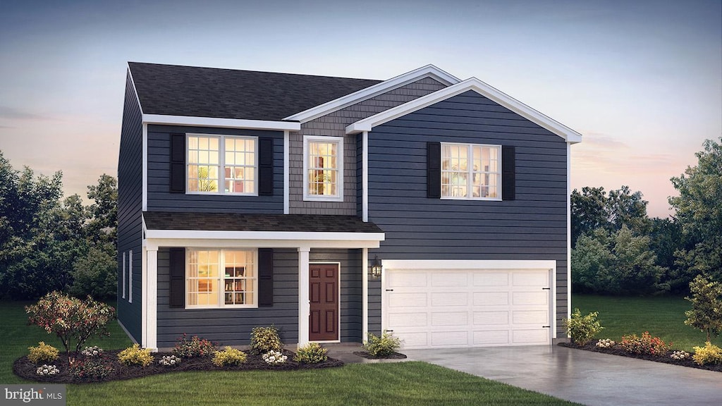 view of front of property featuring a garage and a lawn