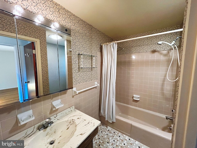 bathroom featuring vanity, shower / bathtub combination with curtain, tile walls, and backsplash