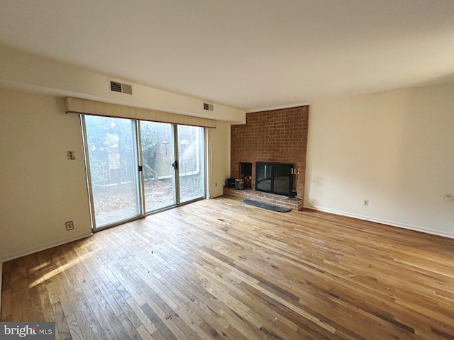 unfurnished living room featuring a fireplace and light wood-type flooring