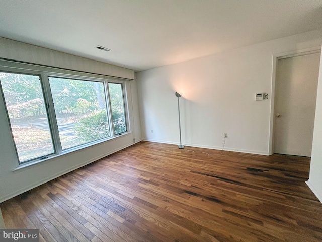 spare room with dark hardwood / wood-style floors