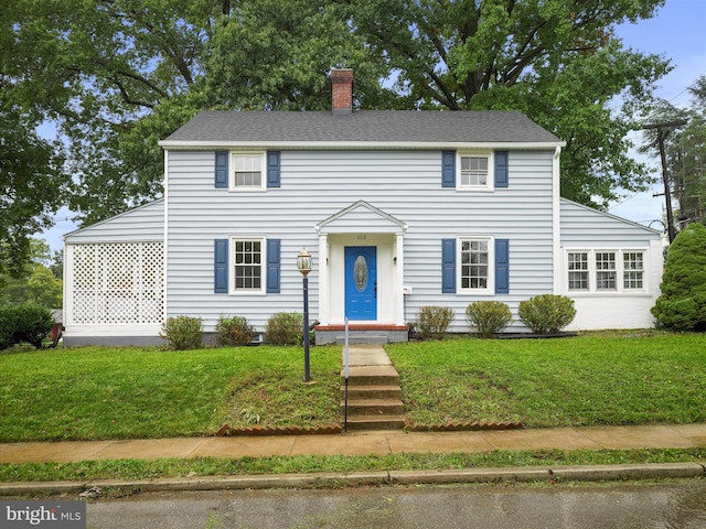 colonial inspired home with a front yard