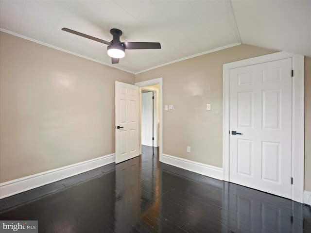 unfurnished bedroom featuring ceiling fan, vaulted ceiling, crown molding, and dark hardwood / wood-style flooring