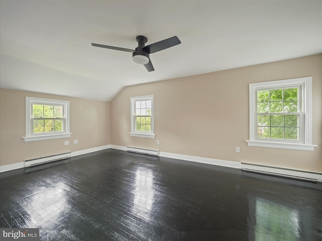 unfurnished room featuring baseboard heating, plenty of natural light, and lofted ceiling