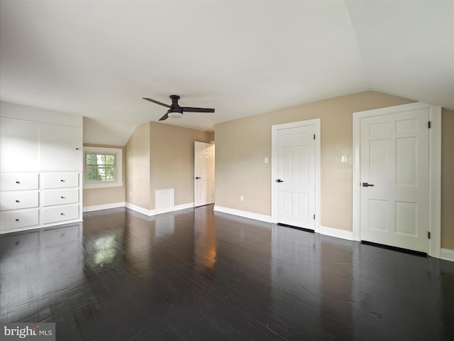 additional living space with ceiling fan, vaulted ceiling, and dark wood-type flooring