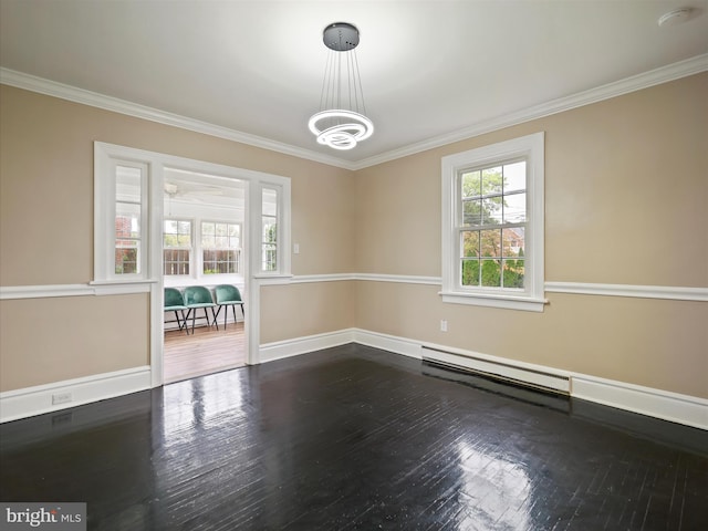 empty room with crown molding, hardwood / wood-style floors, and a baseboard heating unit