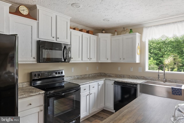 kitchen with white cabinetry, a textured ceiling, black appliances, ornamental molding, and sink