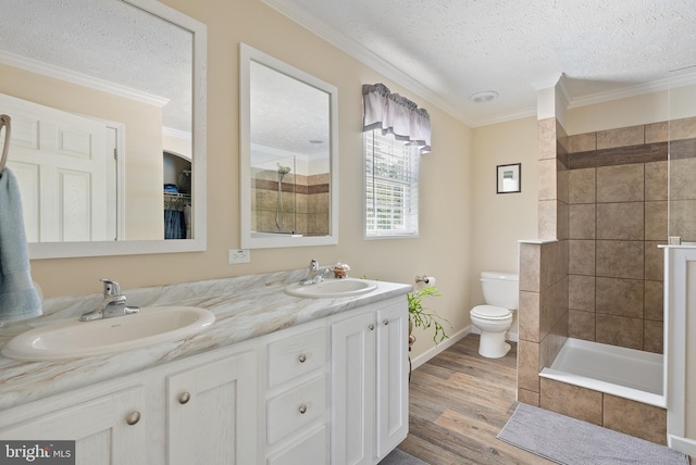 bathroom featuring a textured ceiling, hardwood / wood-style flooring, vanity, and toilet