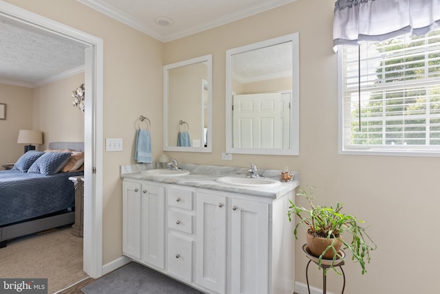 bathroom featuring ornamental molding, a textured ceiling, and vanity