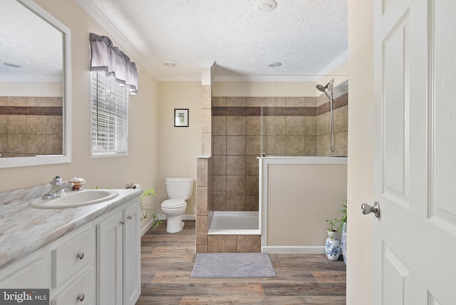 full bathroom with vanity, crown molding, toilet, and hardwood / wood-style flooring