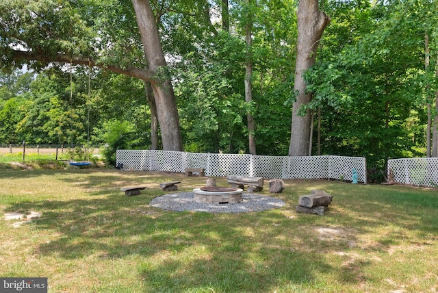 view of yard featuring an outdoor fire pit