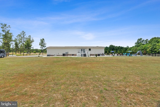 rear view of house with a yard