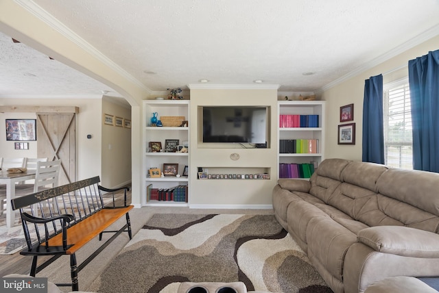 living room with ornamental molding, carpet, a textured ceiling, and a barn door