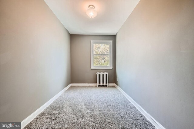 carpeted spare room with radiator