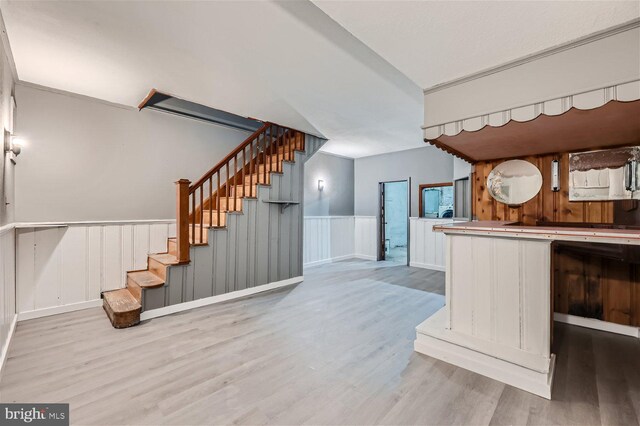 kitchen featuring light hardwood / wood-style flooring and wood walls