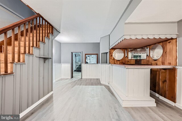 interior space featuring light hardwood / wood-style floors and wooden walls