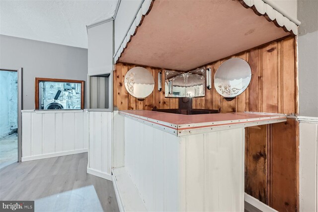 kitchen featuring washer / dryer and light hardwood / wood-style flooring