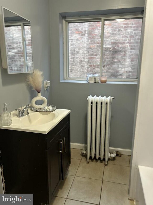 1128 Everett St, Camden, NJ 08104 - bathroom featuring vanity, radiator heating unit, a wealth of natural light, and tile patterned floors