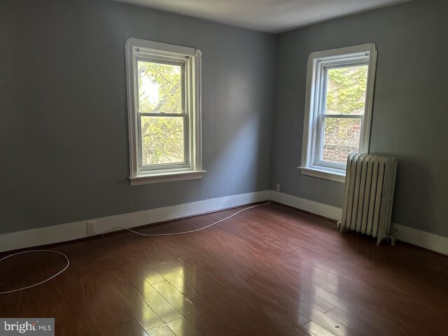 1128 Everett St, Camden, NJ 08104 - empty room with radiator heating unit, a healthy amount of sunlight, and baseboards