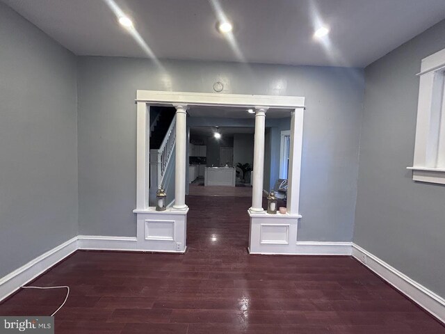 1128 Everett St, Camden, NJ 08104 - empty room with decorative columns, wood finished floors, and baseboards