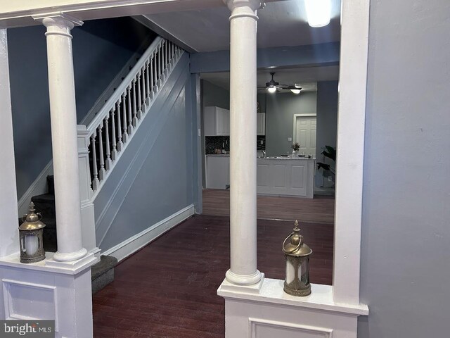 1128 Everett St, Camden, NJ 08104 - stairway featuring ceiling fan, wood finished floors, and ornate columns