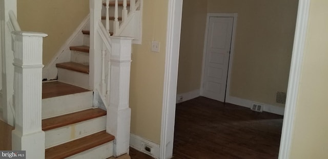 staircase with wood-type flooring