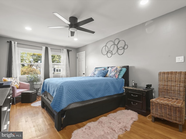 bedroom with light hardwood / wood-style floors and ceiling fan