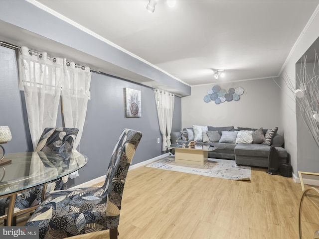 living room with crown molding, a healthy amount of sunlight, and wood-type flooring