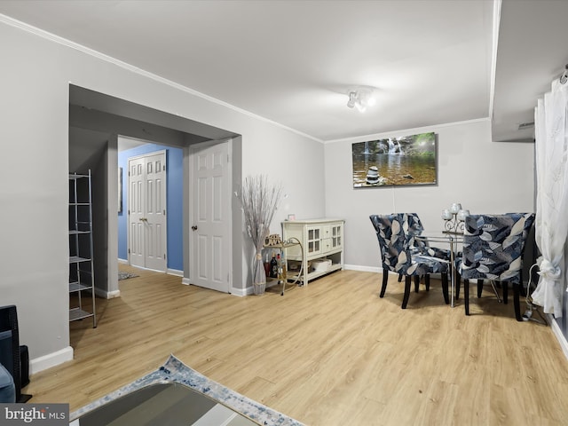 dining area featuring ornamental molding and light wood-type flooring