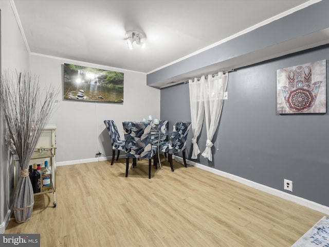 living area with crown molding and wood-type flooring