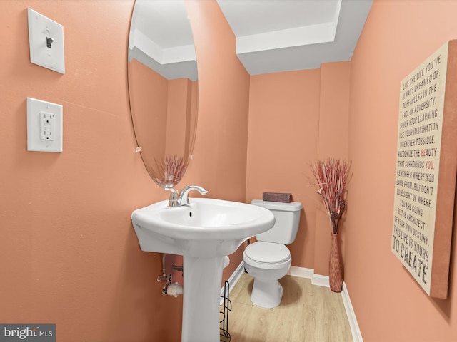 bathroom featuring toilet and wood-type flooring