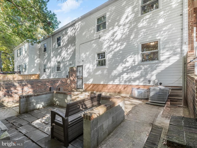 view of patio / terrace with central AC and a fire pit