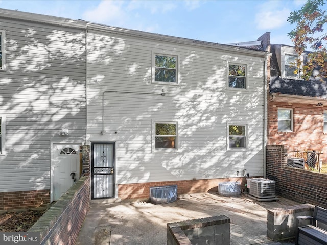 back of house featuring central air condition unit and a patio area