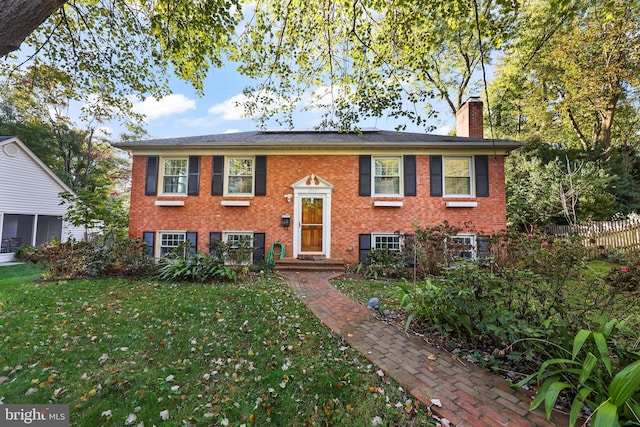 raised ranch featuring a front lawn