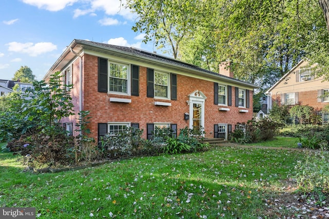 raised ranch with a front yard