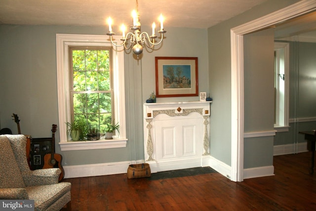 sitting room featuring a notable chandelier and dark hardwood / wood-style floors