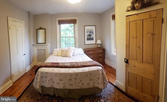 bedroom with a closet and dark wood-type flooring