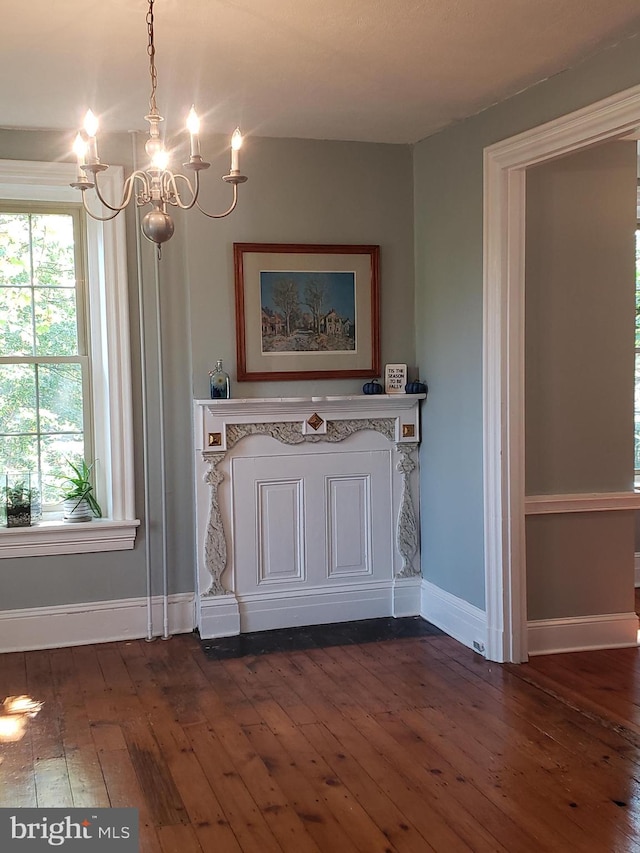 interior details with wood-type flooring and a notable chandelier