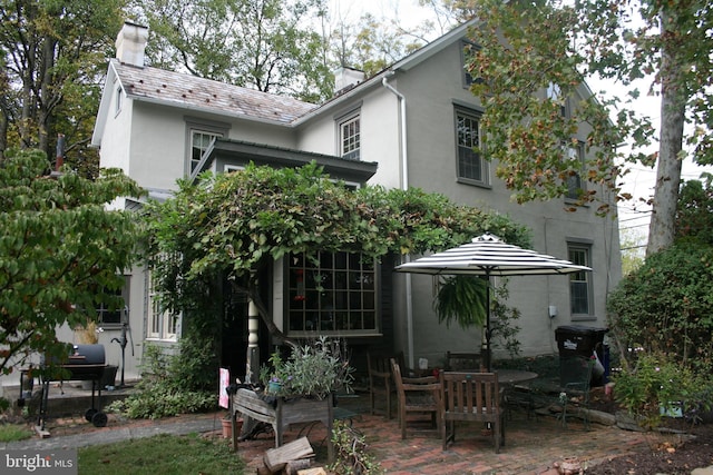 rear view of property featuring a patio