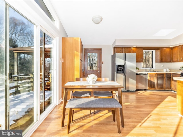 dining room featuring sink and light wood-type flooring