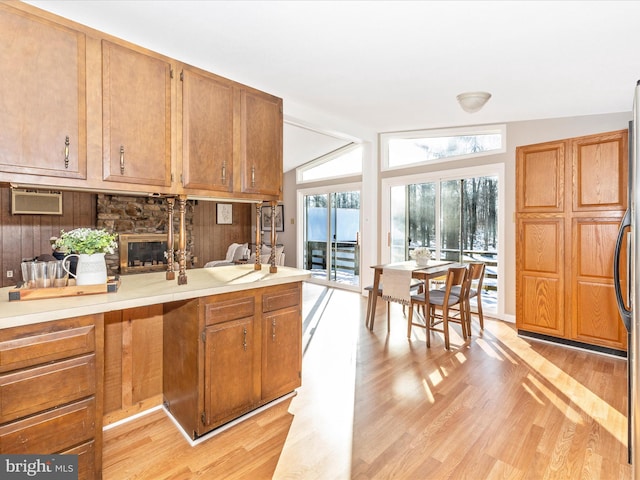 kitchen featuring lofted ceiling, stainless steel refrigerator, and light hardwood / wood-style flooring