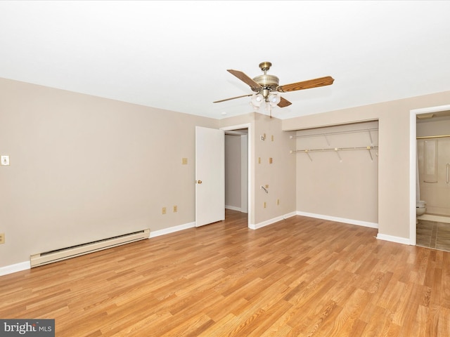 unfurnished bedroom featuring ensuite bathroom, a baseboard radiator, light hardwood / wood-style flooring, ceiling fan, and a closet