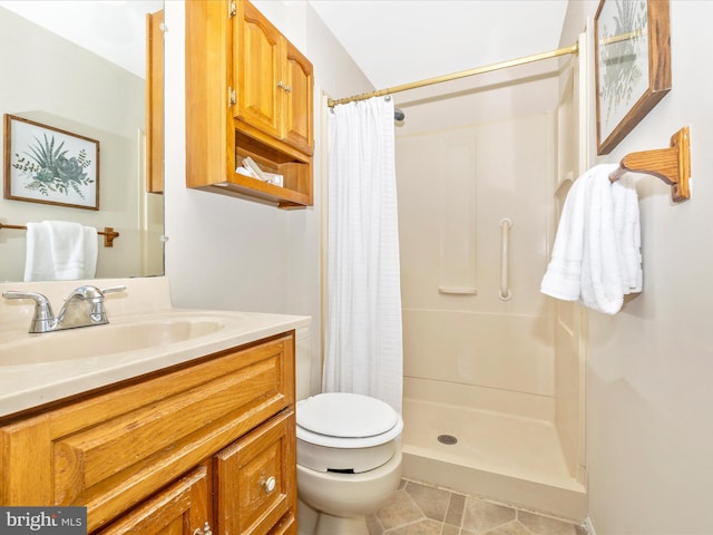 bathroom featuring vanity, toilet, tile patterned floors, and walk in shower